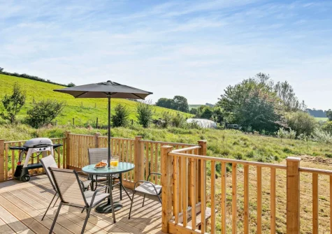 The wrap-around decked terrace, barbecue & alfresco dining area at Nelson Lodge, Barnstaple