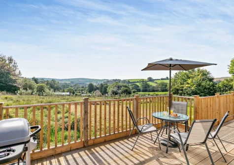 The wrap-around decked terrace, barbecue & alfresco dining area at Nelson Lodge, Barnstaple