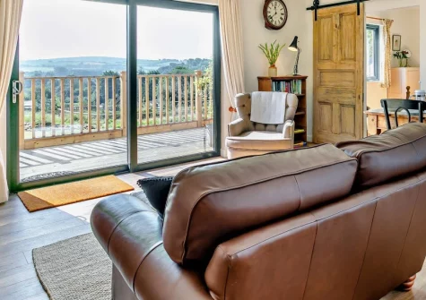 Nelson Lodge, Barnstaple is a beautifully presented single-storey retreat on peaceful outskirts, featuring wraparound decking with countryside views, contemporary Scandinavian-style interiors, and direct access to the legendary Tarka Trail.