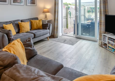 Nelson View, Westward Ho! is a stylish three-bedroon, three-storey house in the heart of this lively seaside town, featuring a private enclosed courtyard, contemporary interiors, and direct access to golden beaches, making it perfect for families.