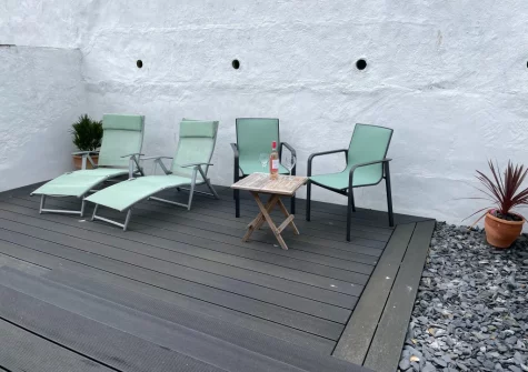 The decked patio & outdoor sitting area at Neptune House, Porthleven