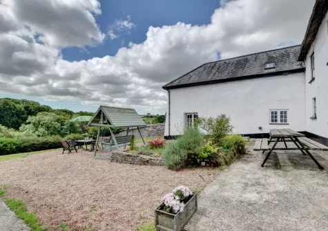The patio, alfresco dining area & garden at Nethercott Manor, Rose Ash