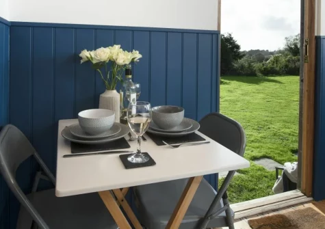 Nori's Nest, Crowlas is a beautifully refurbished shepherds hut offering couples a cosy Cornish escape, complete with a private hot tub, decked patio, firepit and hammock, set in a peaceful field with views towards St Michael's Mount.