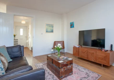 Number 11, St Eval is a stunning three-storey townhouse in rural Cornwall, featuring four bedrooms, a private hot tub, contemporary interiors, and enclosed garden, with golden beaches, Padstow's famous restaurants, and coastal adventures nearby.
