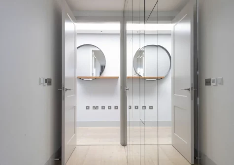 Bedroom #1, with mirrored wardrobe (one of the doors conceals the en-suite shower room), at Number 9 Fistral House, Newquay