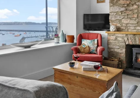 Number Eighty One, Brixham is a romantic first-floor apartment with spectacular harbour views, featuring a cosy wood burner, contemporary interiors, and a prime position in the heart of this fishing town with coastal walks on the doorstep.