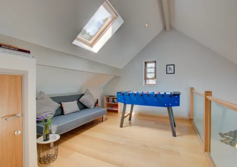 The mezzanine living area, with table football, at Number One at The Creekside, Looe
