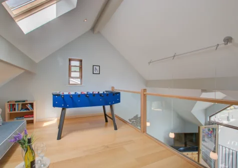 The mezzanine living area, with table football, at Number One at The Creekside, Looe