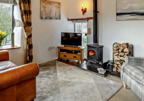 Nuthatch Retreat, Fletchersbridge is a cosy one-bedroom Cornish barn conversion set in 20 acres of private woodland, with sweeping valley views, a wood burner, private patio, fire pit and Cardinham Woods on the doorstep for dog walks.