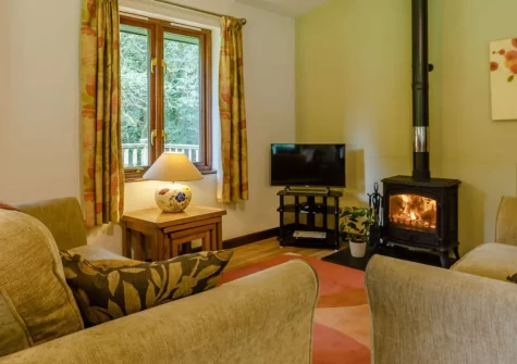 Oak at Waldon Valley Lodges, Bradworthy is a peaceful two-bedroom, dog-friendly lodge beside a well-stocked fishing lake, featuring a cosy wood burner, decked balcony with lake views, woodland walks, and easy access to Devon's countryside and coast.