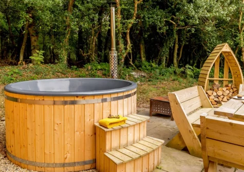 The patio & wood-fired hot tub at Oak Cabin at Hilton Wood, Whitstone