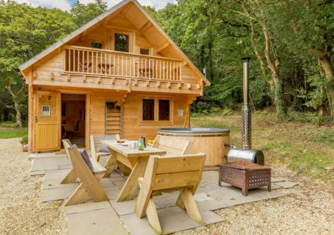 The patio, alfresco dining area & wood-fired hot tub at Oak Cabin at Hilton Wood, Whitstone