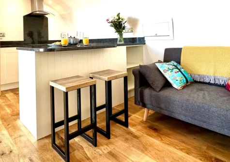 Ocean at The Views, Morwenstow is a beautifully designed eco pod for two, nestled on an organic farm with breathtaking panoramic views stretching across rolling fields to Lundy Island, complete with wood burner warmth and direct coastal path access.