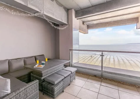 The patio balcony & outdoor sitting area at Ocean Bay, Westward Ho!