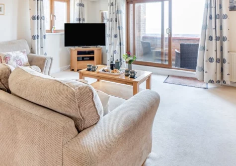 Ocean Park 16, Westward Ho! is a contemporary second-floor apartment just a ten-minute walk from the town's magnificent sandy beach, featuring two private balconies with sea views, modern interiors, and easy access to North Devon's attractions.