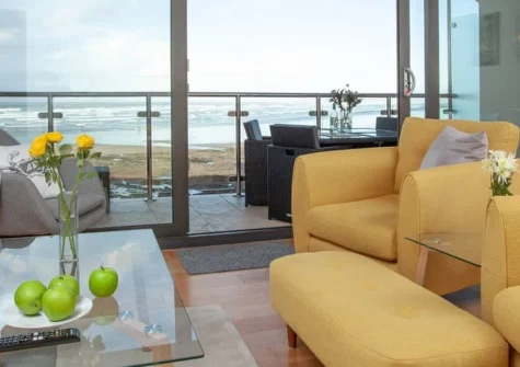 Ocean Serenity, Westward Ho! is a stunning reverse-level duplex directly on Golden Bay beach, featuring floor-to-ceiling windows with panoramic Atlantic views, a private balcony for sunset watching, and contemporary coastal interiors.
