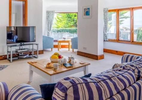 Ocean View, Holywell Bay is a spacious four-bedroom beach house with stunning sea and beach views, a private enclosed garden with barbecue, off-road parking, and easy access to the coast path and golden sands, perfect for family holidays.