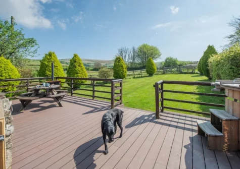 The decked patio, alfresco dining area & wood fired hot tub at Old Dairy Barn, Challacombe