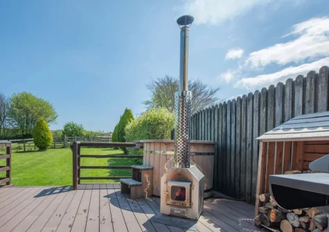 The decked patio & wood fired hot tub at Old Dairy Barn, Challacombe