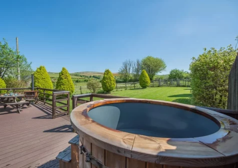 The decked patio & wood fired hot tub at Old Dairy Barn, Challacombe