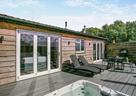 The enclosed decked terrace, barbecue, alfresco dining area & hot tub at Old Spot, Westward Ho!