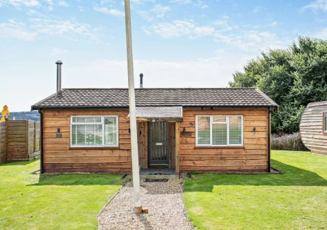 Old Spot is a unique cedar lodge style property with a a cosy wood burner, private sunken hot tub&  enclosed decked garden with views over fields