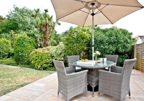 The patio, alfresco dining area & garden at Oldway Apartment, Paignton
