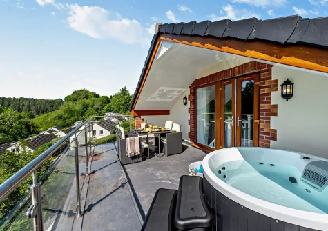 The balcony, alfresco dining area & hot tub at Olive Lodge, High Bickington