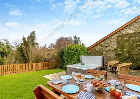 The patio, barbecue, alfresco dining area, hot tub & garden at Oriel Cottage, Muddiford