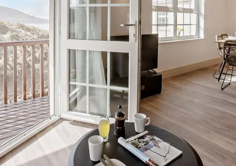 Orleigh, Croyde Bay is a recently refurbished 3-bedroom beachside apartment with a private balcony and direct beach access. It's perfect for families seeking surfing adventures, coastal relaxation, and unforgettable holiday memories in North Devon.