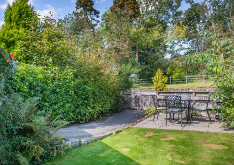 The patio, alfresco dining area & enclosed garden at Otterbridge at Penrose Burden, St Breward