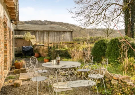 The patio, barbecue, alfresco dining area & enclosed garden at Otter's Holt, Lower Washfield