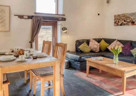 Otter's Holt, Lower Washfield is a restored cider barn within a 38-acre working farm, featuring riverside meadows and woodland to explore, a large enclosed garden perfect for dogs, and the River Exe flowing just metres from your door.