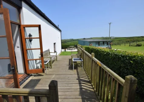 The decked patio & outdoor sitting area at Owl Barn at The Retreat, Higher Clovelly