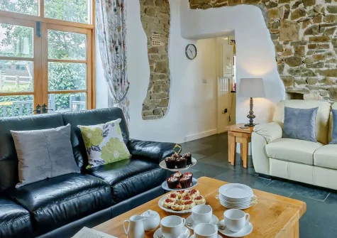 Owl Barn at The Retreat, Higher Clovelly is a stunning four-bedroom barn conversion with far-reaching coastal views, private hot tub, and cosy wood burner. Perfect for families seeking coastal adventures and peaceful countryside tranquillity.
