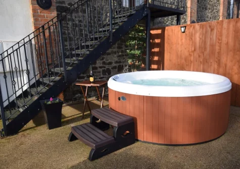 The patio & hot tub at Owls Nest at Hilltown Farm, Mariansleigh