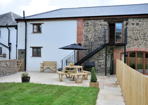 The patio, barbecue, alfresco dining area & enclosed garden at Owls Nest at Hilltown Farm, Mariansleigh