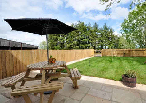 The patio, barbecue, alfresco dining area & enclosed garden at Owls Nest at Hilltown Farm, Mariansleigh
