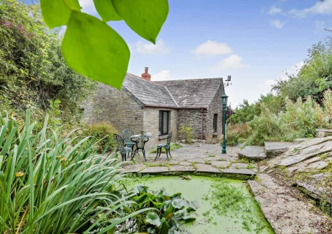 The patio & outdoor sitting area overlooking the ornate pond at Padstow Wagon House, Padstow