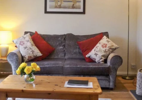 Palm Leas, Ilfracombe is a charming single-storey bungalow nestled in tranquil gardens with panoramic sea views, featuring a wood burner for cosy evenings, private patio with barbecue, and easy access to North Devon's stunning coastline.