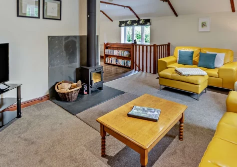 Parr Cottage, Two Waters Foot is a beautiful reverse-level retreat surrounded by tranquil woodland, featuring elevated decking with verdant views, a separate games barn with pool table, and peaceful enclosed gardens perfect for families.