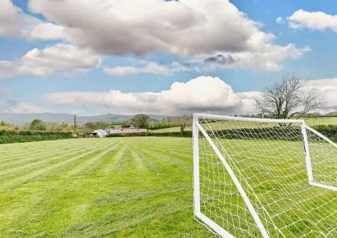 Adjacent to the cottage is an acre of fenced grass for games and your dogs to enjoy