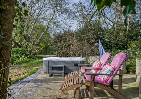 The secluded hot tub & sun loungers at Peace Cottage, Riverview, Bere Alston