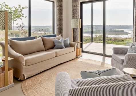 Peace Cottage, Riverview, Bere Alston is a beautifully appointed one-bedroom riverside cabin offering a private hot tub, shared heated pool, and stunning panoramic Tamar Valley views, set within a breathtaking Area of Outstanding Natural Beauty.