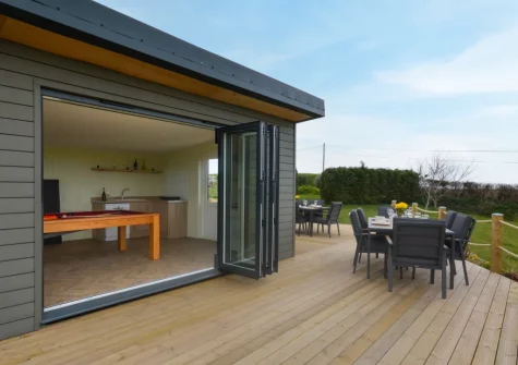 The games room, decked patio & alfresco dining area at Peacehay Barn, Little Petherick
