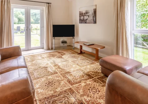 Peal Cottage, Two Waters Foot is a charming three-bedroom Cornish retreat set in peaceful countryside, featuring a light-filled living space, private enclosed garden, and seven acres of shared woodland grounds with freshwater swimming spots.