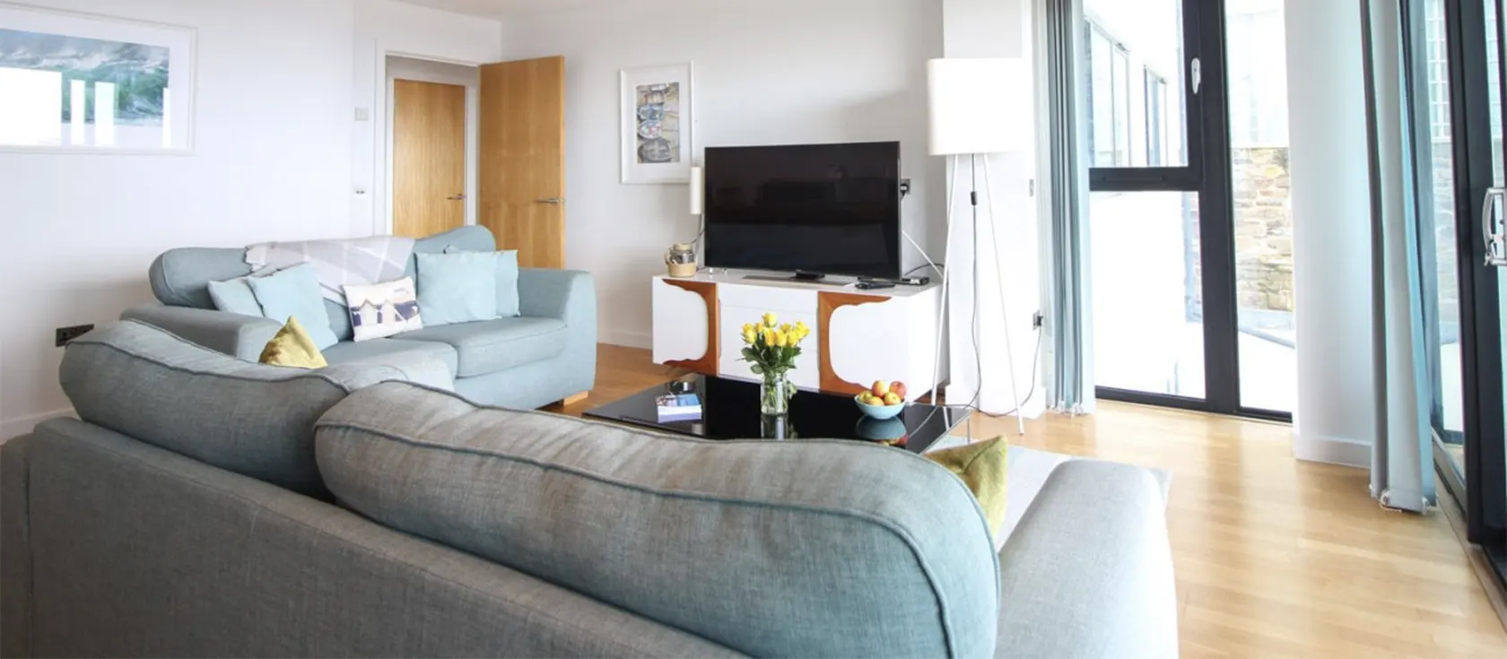 Pearl Three, Newquay is a modern two bedroom, two bathroom luxury apartment. Open floorplan with sofas, dining table, breakfast bar & fully equipped kitchen. Doors to private patio with superb sea views. Parking. Surfboard storage. Walk just 120m to Fistral Beach.