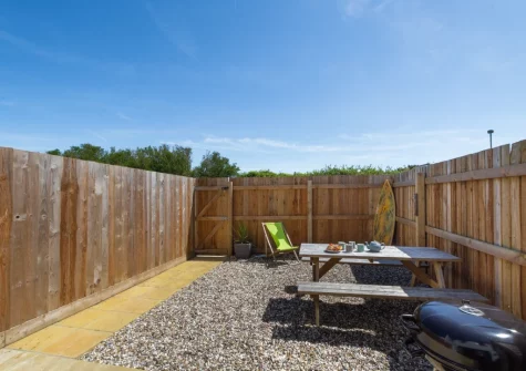 The paved patio garden, barbecue & alfresco dining area at Pebble House, Newquay