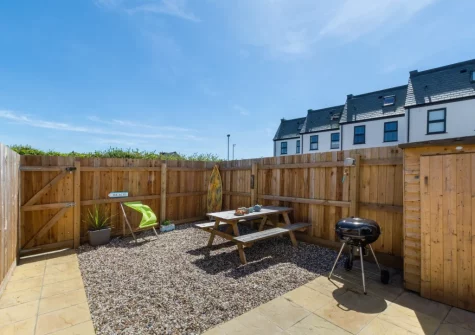 The paved patio garden, barbecue & alfresco dining area at Pebble House, Newquay