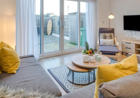 Pebble House, Newquay is a contemporary three-bedroom home just moments from Fistral Beach, featuring a private balcony with bay views, enclosed garden with outdoor dining, and easy access to Newquay's surf, shops and family attractions.